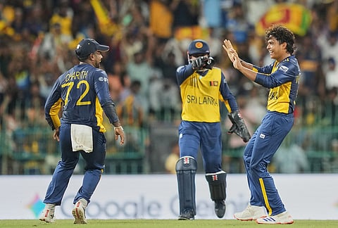 Sri Lanka's Dunith Wellalage, right, celebrates with teammates the wicket of New Zealand's Daryl Mitchell during the T20 World Cup cricket match between Sri Lanka and New Zealand in Colombo, Sri Lanka.
