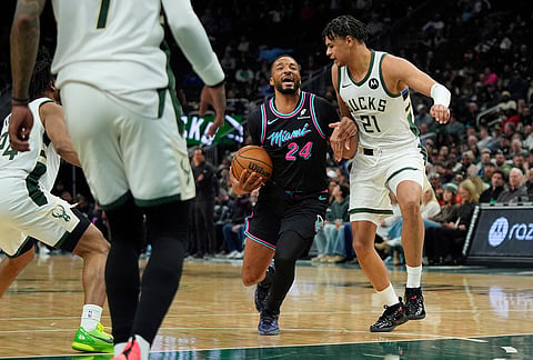 Miami Heat's Norman Powell (24) drives to the basket against Milwaukee Bucks' Ousmane Dieng during the second half of an NBA basketball game, in Milwaukee.
