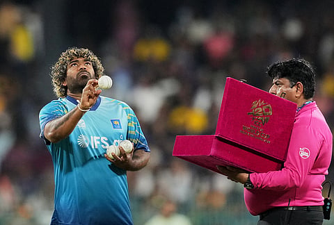 Sri Lanka's fast bowling coach Lasith Malinga checks balls before the start of the T20 World Cup cricket match between Sri Lanka and New Zealand in Colombo, Sri Lanka.