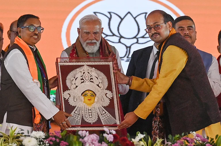 PM Narendra Modi received an idol of Goddess Durga during the public rally at Singur, Hooghly district, on January 18, 2026 in Singur, India. PM Modi accused the TMC government of playing with national security by aiding infiltrators for vote-bank politics, and said it was necessary to end its maha jungle raj in West Bengal to pave the way for development and good governance. - IMAGO / Hindustan Times