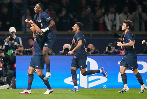 Paris Saint-Germain players celebrate after a goal during a Champions League second leg playoff soccer match between Paris Saint-Germain and Monaco in Paris.