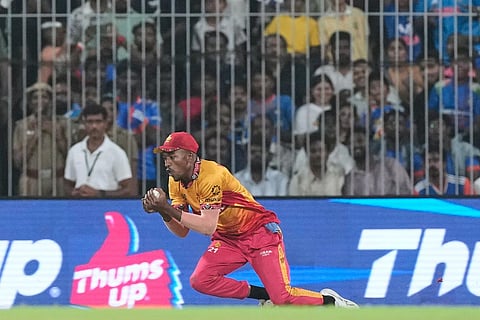 Zimbabwe's Tashinga Musekiwa takes the catch to get India's captain Suryakumar Yadav during the T20 World Cup cricket match between India and Zimbabwe in Chennai, India.