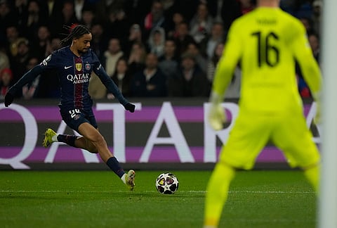 PSG's Bradley Barcola shoots during a Champions League second leg playoff soccer match between Paris Saint-Germain and Monaco in Paris.