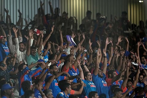 Indian fans cheer for their team during the T20 World Cup cricket match between India and Zimbabwe in Chennai, India.