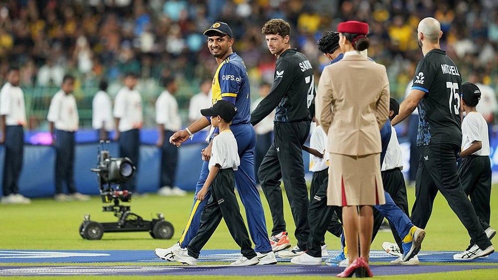 | Photo: AP/Eranga Jayawardena : Sri Lanka's captain Dasun Shanaka, left, and New Zealand's captain Mitchel Santner arrive for their national anthem before the start of their T20 World Cup cricket match between Sri Lanka and New Zealand in Colombo, Sri Lanka.