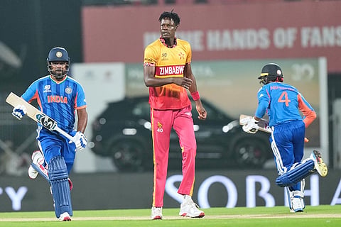 India's Sanju Samson, left, and Abhishek Sharma, right, run between the wickets as Zimbabwe's Blessing Muzarabani looks on during the T20 World Cup cricket match between India and Zimbabwe in Chennai, India.