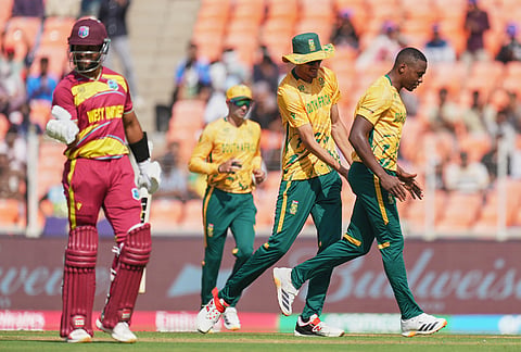 South Africa's Marco Jansen, second right, pats teammate Kagiso Rabada for taking the wicket of West Indies' captain Shai Hope, left, during the T20 World Cup cricket match between South Africa and West Indies in Ahmedabad.