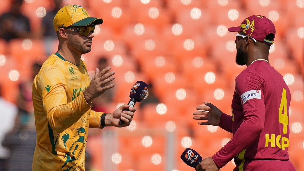 Photo: AP : South Africa's captain Aiden Markram, left, and West Indies' skipper Shai Hope shake hands after the coin toss of their T20 World Cup match in Ahmedabad.