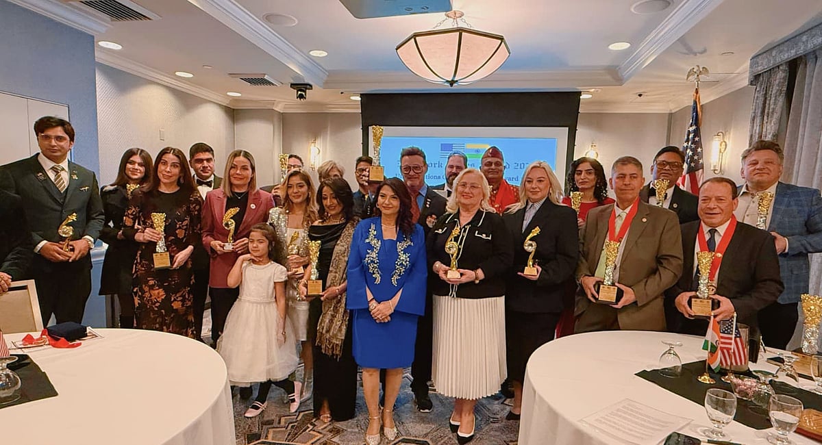 Arun Kar and Nidhi Kar holding awards at formal ceremony in New York with honorees