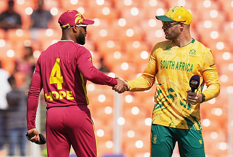 South Africa's captain Aiden Markram, right, and West Indies' captain Shai Hope shake hands after the coin toss of the T20 World Cup cricket match between South Africa and West Indies in Ahmedabad.