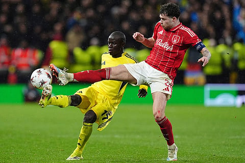 Fenerbahce's N'Golo Kante, left, and Nottingham Forest's Neco Williams battle for the ball during the Europa League knockout phase play-off second leg match between Nottingham Forest and Fenerbahce in Nottingham, England