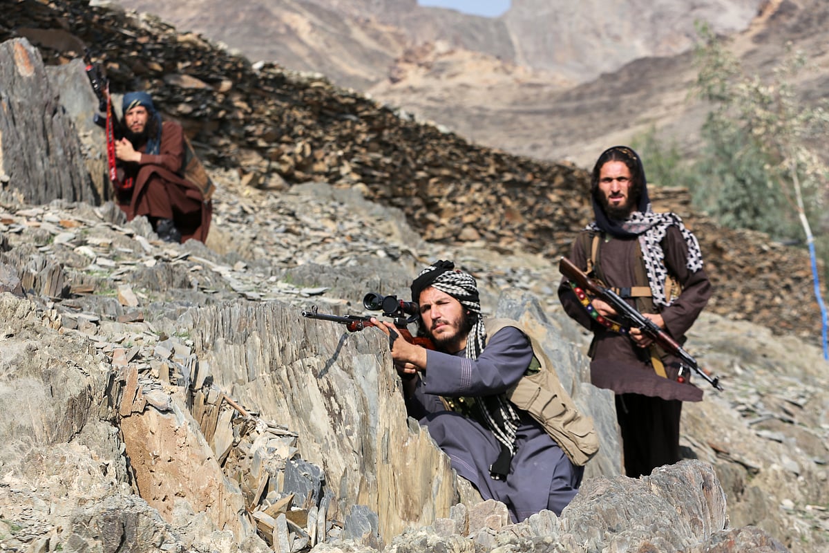 AP : Afghan Taliban soldiers look toward the Pakistani side, with one peering through the sight of his rifle, on the Afghan side of the Torkham border crossing with Pakistan in Torkham, Afghanistan, Friday, Feb. 27, 2026.