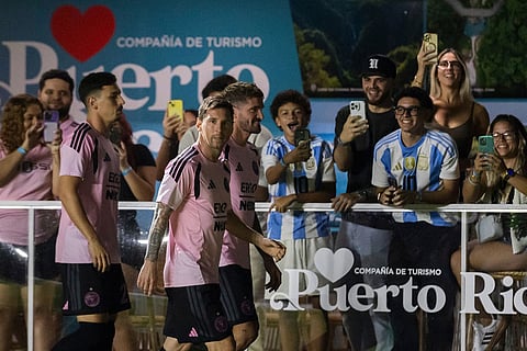 Inter Miami's Lionel Messi walks in front of fans during warmups before an international friendly soccer match against Ecuador's Independiente del Valle in Bayamon, Puerto Rico.