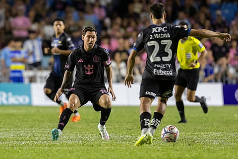 Inter Miami's Lionel Messi competes for the ball with Juan Viacava of Ecuador's Independiente del Valle during an international friendly soccer match in Bayamon, Puerto Rico.