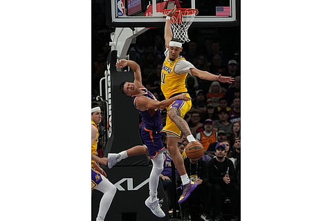 Los Angeles Lakers center Jaxson Hayes (11) fouls Phoenix Suns guard Grayson Allen during the first half of an NBA basketball game in Phoenix.