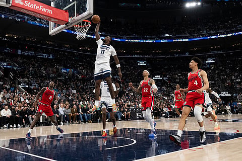 Minnesota Timberwolves center Naz Reid (11) dunks during the second half of an NBA basketball game against the Los Angeles Clippers in Inglewood, Calif.