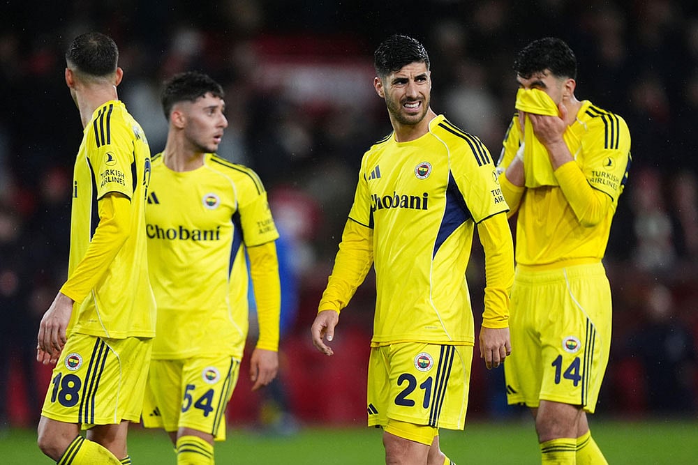 | Photo: Mike Egerton/PA via AP : Fenerbahce's Marco Asensio, second from right, and teammates react after the Europa League knockout phase play-off second leg match between Nottingham Forest and Fenerbahce in Nottingham, England.