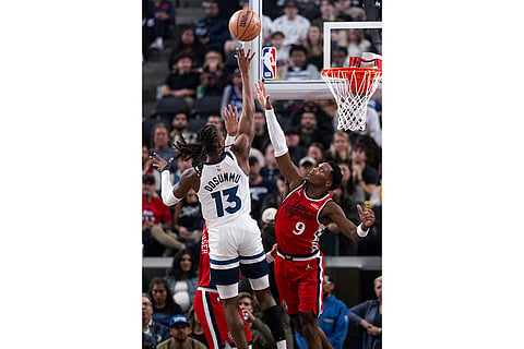 Minnesota Timberwolves guard Ayo Dosunmu (13) shoots over Los Angeles Clippers guard Bennedict Mathurin (9) during the first half of an NBA basketball game in Inglewood, Calif.