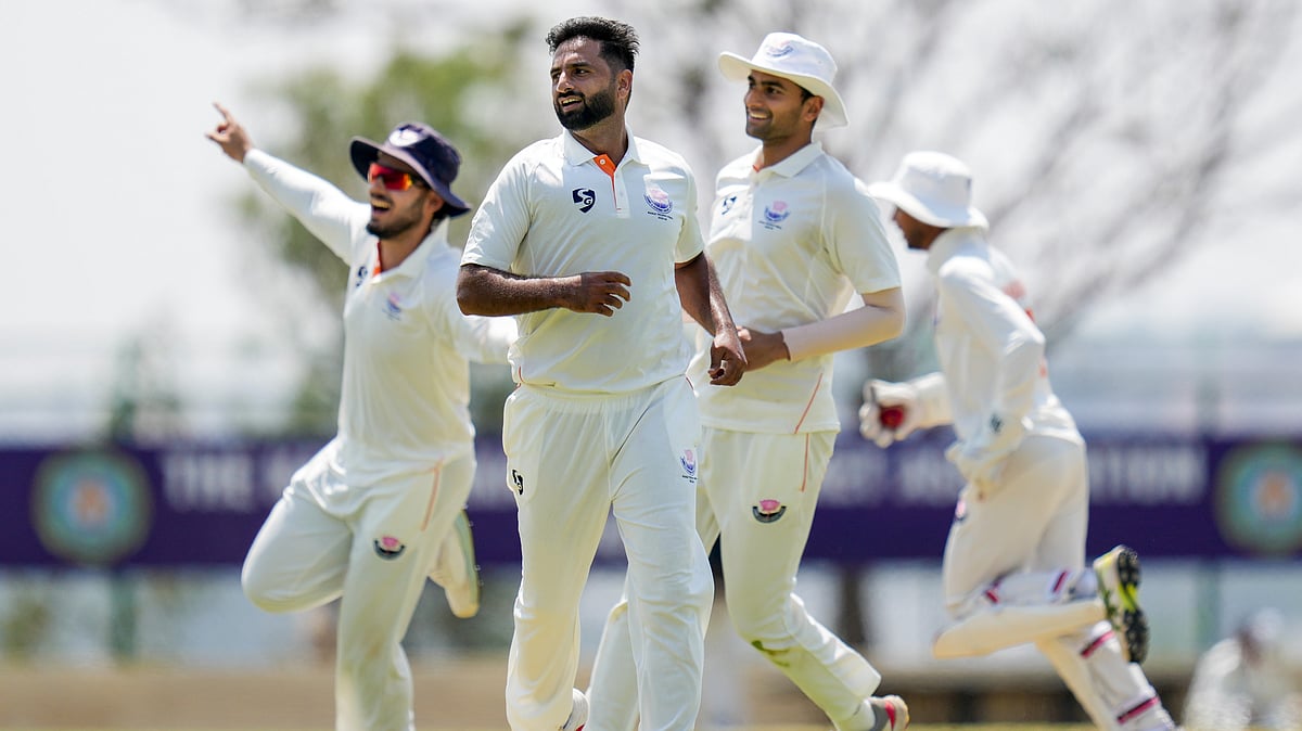 PTI : Jammu and Kashmir's Auqib Nabi celebrates with teammates after taking the wicket of Karnataka's Smaran Ravichandran during the third day of the Ranji Trophy 2025-26 final at the KSCA Cricket Stadium.