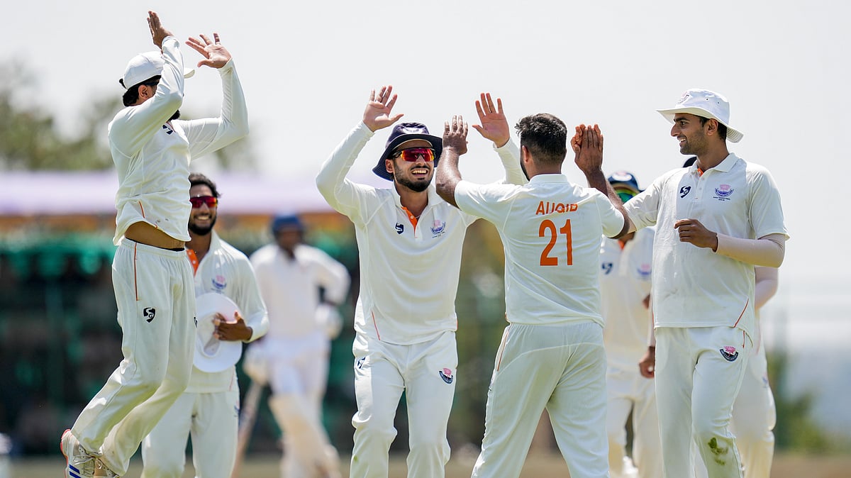PTI : Jammu and Kashmir's Auqib Nabi celebrates with teammates after taking the wicket of Karnataka's Smaran Ravichandran during the third day of the Ranji Trophy 2025-26 final at the KSCA Cricket Stadium.