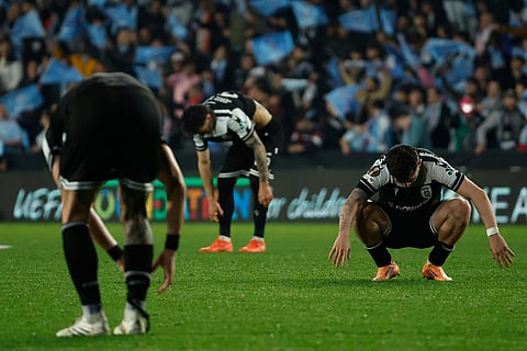 PAOK's players react at the end of the second leg of the Europa League playoff soccer match between Celta Vigo and PAOK in Vigo, Spain.