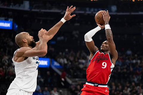 Los Angeles Clippers guard Bennedict Mathurin, right, looks to shoot as Minnesota Timberwolves center Rudy Gobert, left, defends during the first half of an NBA basketball game in Inglewood, Calif.