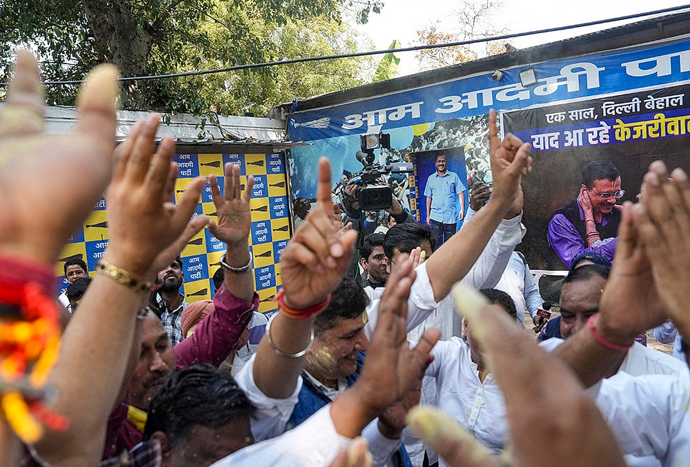 | Photo: PTI/Karma Bhutia : AAP members celebrate after the party's national convener Arvind Kejriwal and party leader Manish Sisodia were discharged by a Delhi court in a liquor policy case, in New Delhi.