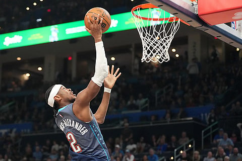Oklahoma City Thunder guard Shai Gilgeous-Alexander goes up to shoot during the second half of an NBA basketball game against the Denver Nuggets  in Oklahoma City.