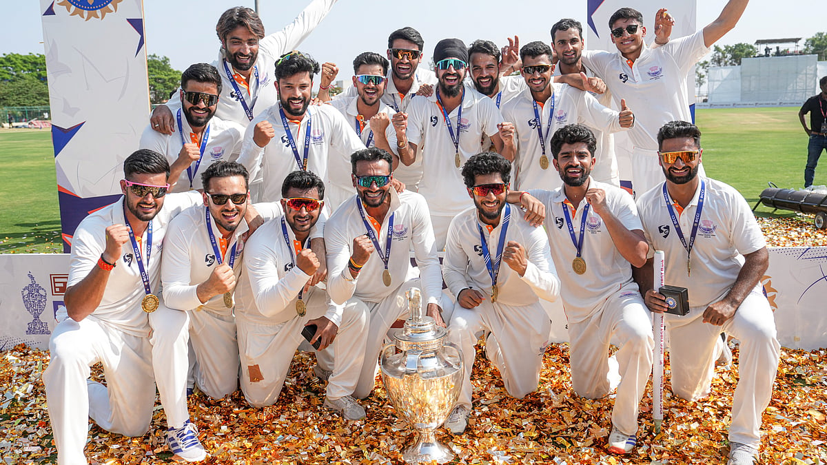 PTI : Jammu and Kashmir players pose with the trophy after the team's victory in the Ranji Trophy 2025-26 final against Karnataka, at KSCA Stadium in Hubballi.