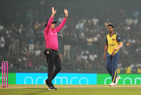 Sri Lanka's Dushmantha Chameera, right, watches the umpire signalling for a six during the T20 World Cup cricket match between Pakistan and Sri Lanka in Pallekele, Sri Lanka.