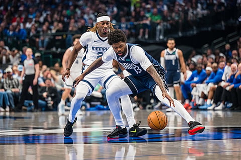 Dallas Mavericks forward Naji Marshall (13) and Memphis Grizzlies guard Ty Jerome (2) go after the ball during an NBA basketball game in Dallas.