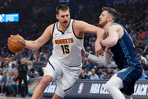 Denver Nuggets center Nikola Jokic, left, drives past Oklahoma City Thunder center Isaiah Hartenstein, right, during the first half of an NBA basketball game in Oklahoma City.