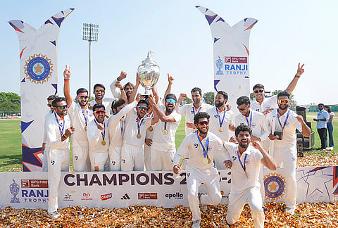Jammu and Kashmir players celebrate with the trophy after winning the Ranji Trophy 2025-26 final cricket match against Karnataka, at KSCA Stadium, in Hubballi, Karnataka.