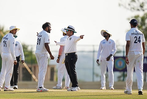 Karnataka's Vijaykumar Vyshak, front second left, interacts with field umpire Rohan Pandit, centre, on day four of the Ranji Trophy 2025-26 final cricket match between Karnataka and Jammu and Kashmir, at KSCA Cricket Stadium, in Hubballi, Dharwad district.