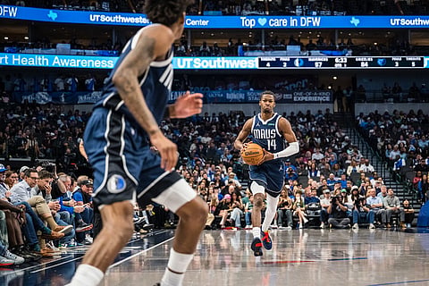 Dallas Mavericks guard Miles Kelly (14) looks to pass the ball during an NBA basketball game against the Memphis Grizzlies in Dallas.