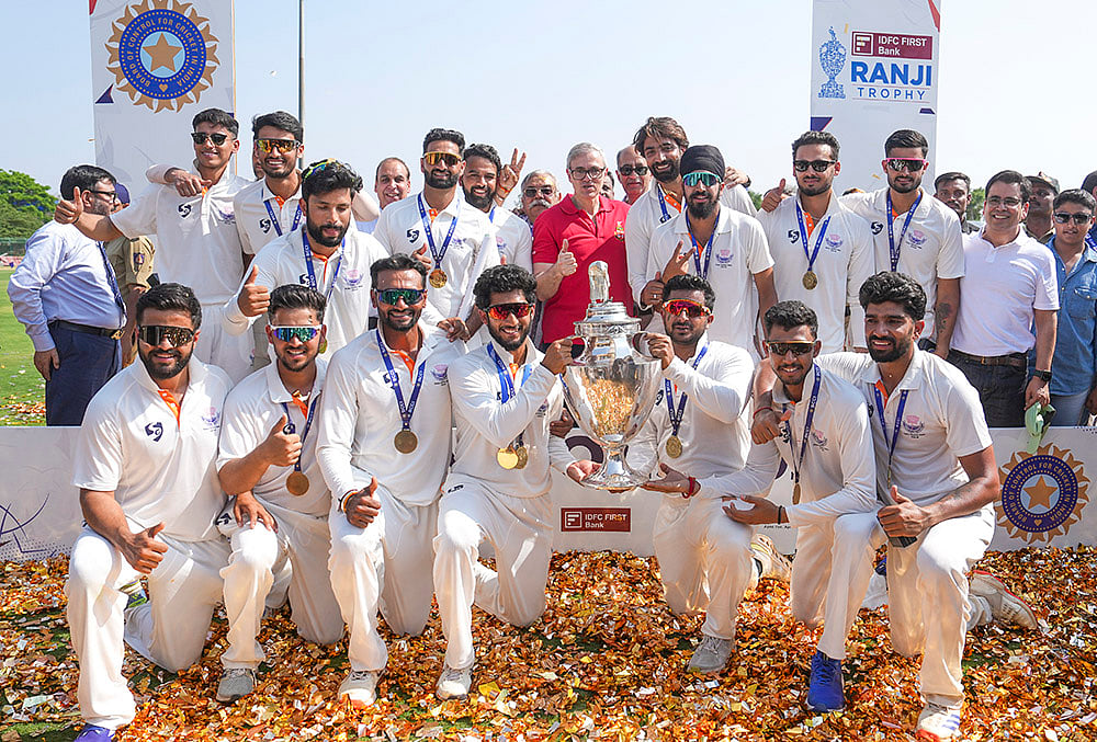 | Photo: PTI/Shailendra Bhojak : Jammu and Kashmir Chief Minister Omar Abdullah poses with players during the felicitation ceremony after the team's victory in the Ranji Trophy 2025-26 final cricket match against Karnataka, at KSCA Stadium, in Hubballi, Karnataka.