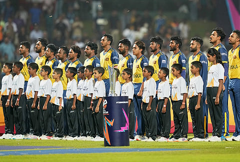 Sri Lanka's players stand up for the national anthems before the start of the T20 World Cup cricket match between Pakistan and Sri Lanka in Pallekele, Sri Lanka.