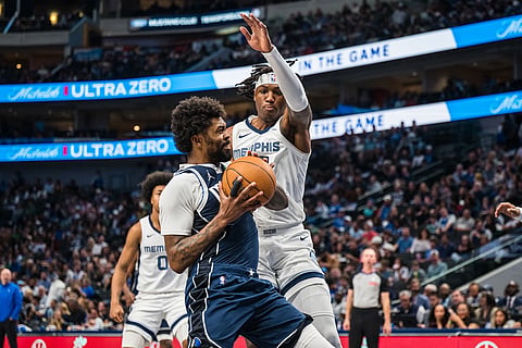 Dallas Mavericks forward Naji Marshall, center left, guards the ball against Memphis Grizzlies forward GG Jackson, center right, during an NBA basketball game in Dallas.