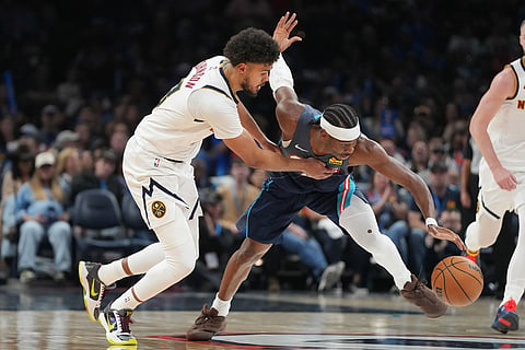 Oklahoma City Thunder guard Shai Gilgeous-Alexander, second from left, goes after the ball in front of Denver Nuggets guard Julian Strawther, left, during the second half of an NBA basketball game in Oklahoma City.