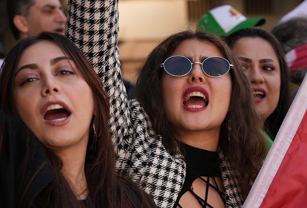| Photo: AP/Hiro Komae : Iranians living in Japan and their families gather near the Iranian Embassy in Tokyo to show support Saturday's U.S.-Israel strikes on Iran. 