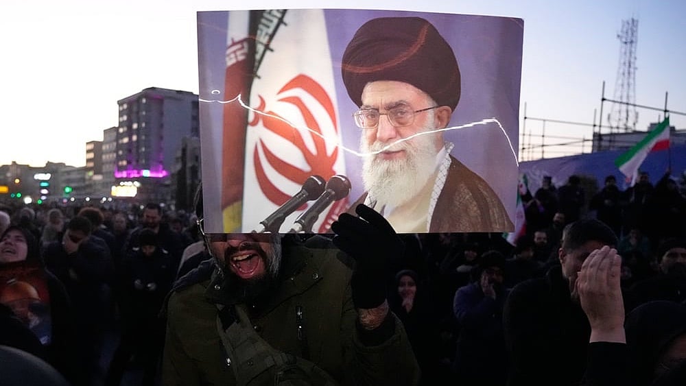 | Photo: AP/Vahid Salemi : Government supporters mourn in a gathering after state TV officially announced the death of Iranian Supreme Leader Ayatollah Ali Khamenei, shown in the poster, in Tehran, Iran.