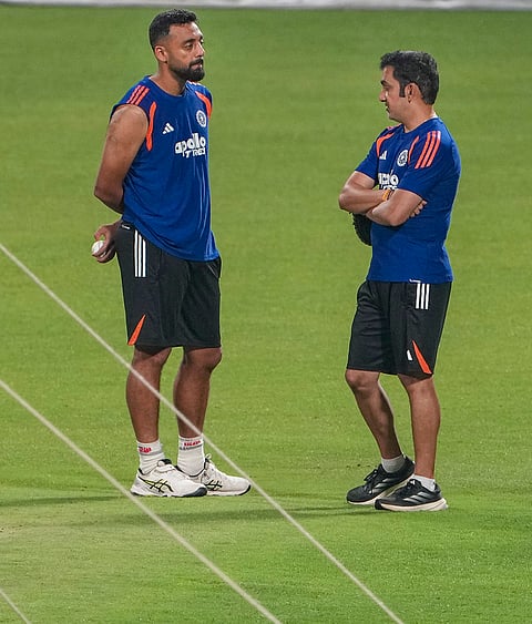 India's Varun Chakravarthy, left, and head coach Gautam Gambhir during a practice session ahead of an ICC Men's T20 World Cup 2026 cricket match between India and West Indies, at the Eden Gardens, in Kolkata, West Bengal.