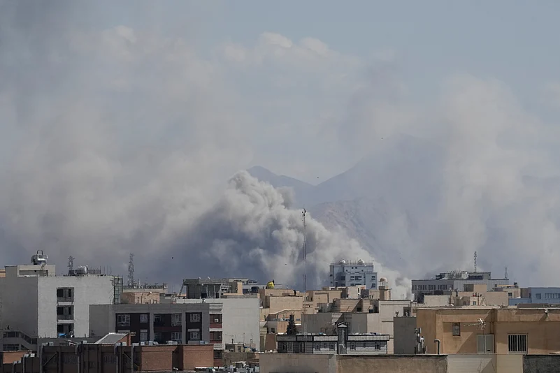 Smoke rises up after a strike in Tehran, Iran, Sunday, March 1, 2026.