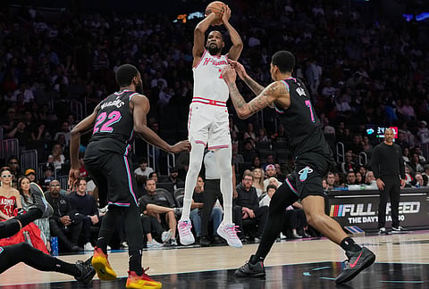 Miami Heat center Kel'el Ware (7) shoots over Miami Heat forward Andrew Wiggins (22) and center Kel'el Ware (7) during the second half of an NBA basketball game in Miami.