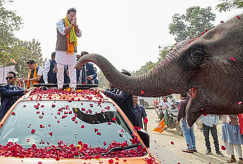 Assam Chief Minister Himanta Biswa Sarma greets an elephant during the 'Jan Ashirwad Yatra', in Morigaon, Assam.