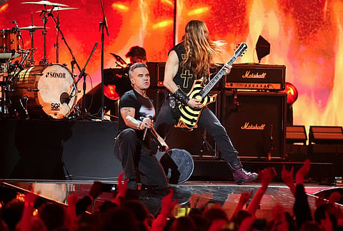 Robbie Williams, centre left performs during the Brit Awards 2026 in Manchester, England.