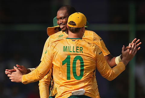 South Africa's Lungi Ngidi, right, celebrates with teammates the wicket of Zimbabwe's Ryan Burl during the T20 World Cup cricket match between South Africa and Zimbabwe in New Delhi.