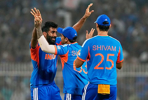 India's Jasprit Bumrah, left, celebrates with captain Suryakumar Yadav the wicket of West Indies' Roston Chase during the T20 World Cup cricket match between India and West Indies in Kolkata.