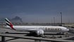 Iran Hits Back: Targets US Assets, Allies Across West Asia Altaf Qadri : A plume of smoke caused by an Iranian strike is seen in the background an an Emirates plane is parked at the Dubai International Airport after its closure in Dubai, United Arab Emirates, Sunday, March 1, 2026.