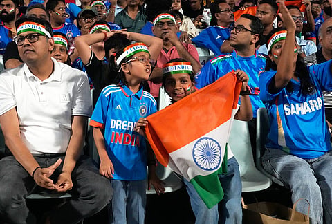 Indian fans cheer for their team during the T20 World Cup cricket match between India and West Indies in Kolkata.